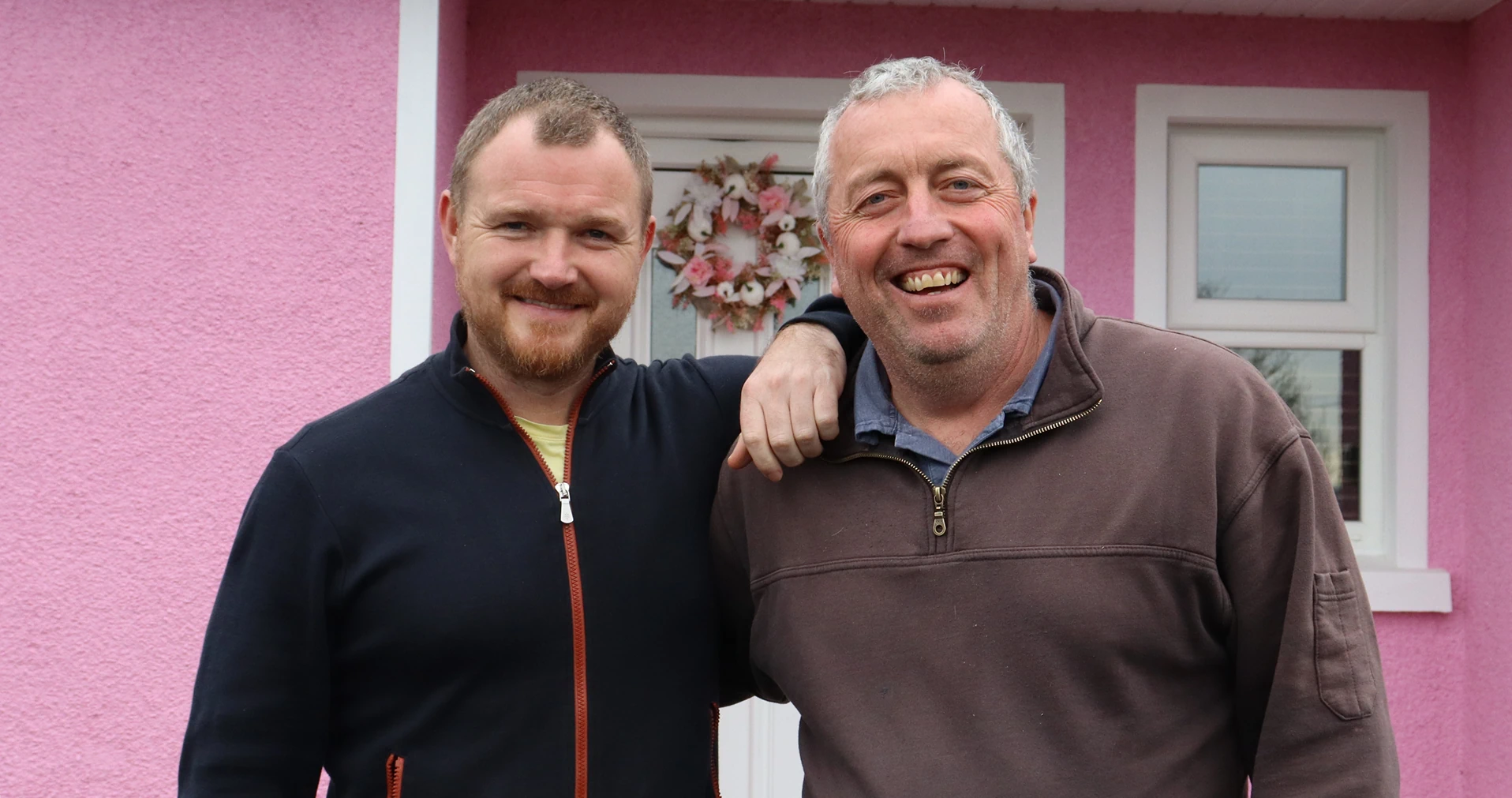 A photo of Sean O'Neill and Niall Rice by the front door to Lily's Pink House
