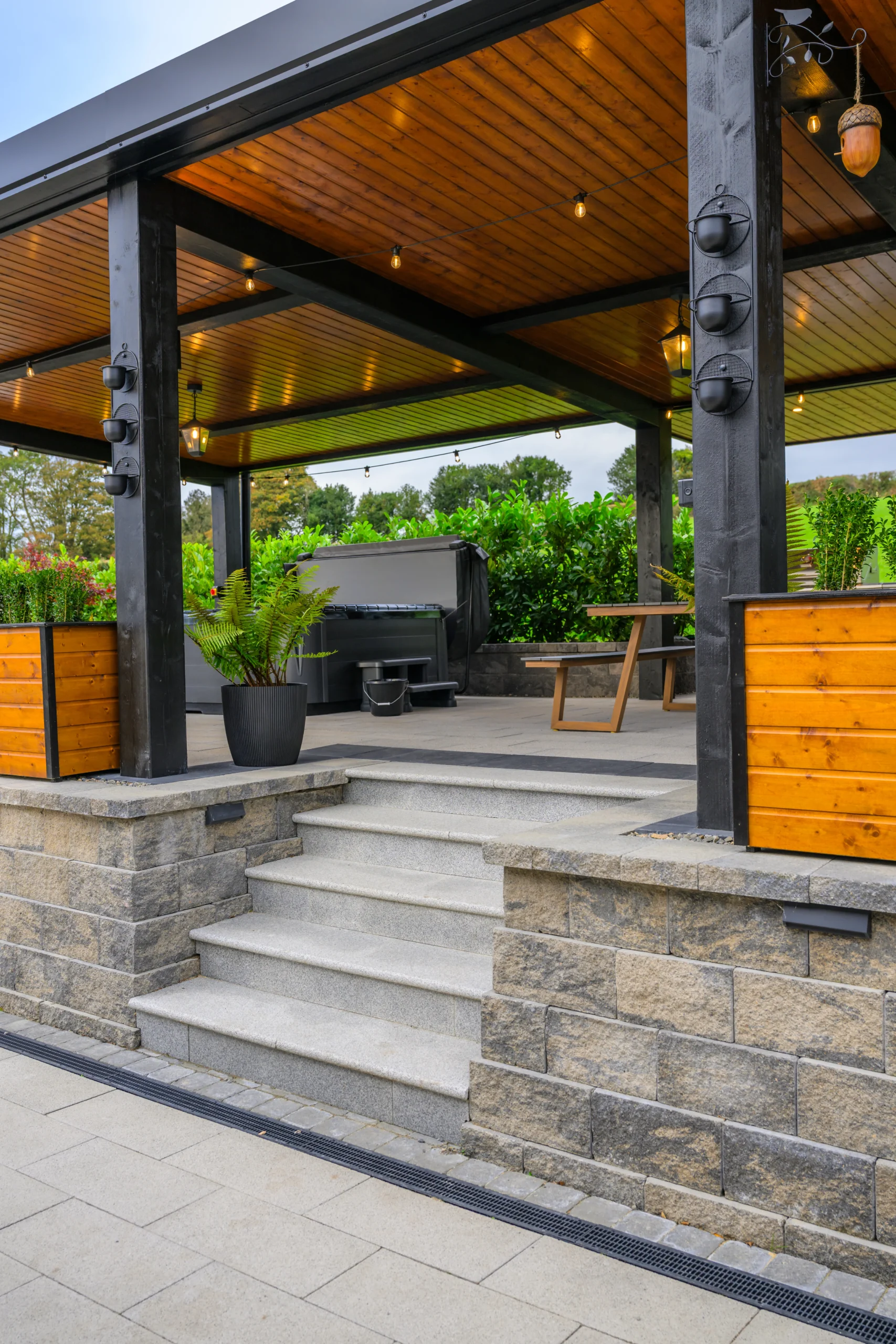 An image of the stairs leading up to the Aunt Minnie's Relaxation area, in the image you can see the bench and hot tub.
