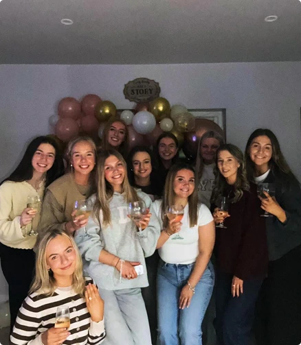 A group photo at Minnie stays of people having fun enjoying a drink