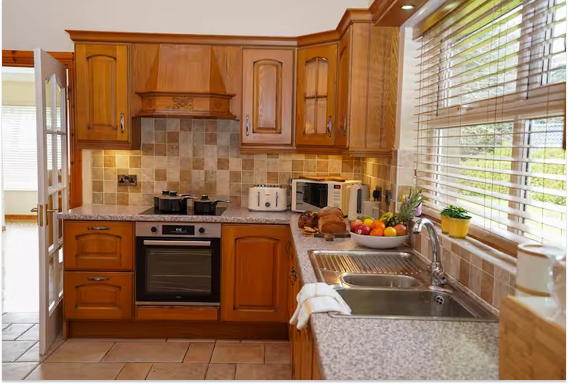 Image of the rustic kitchen at Lily's pink house with a lot of natural light from the window.