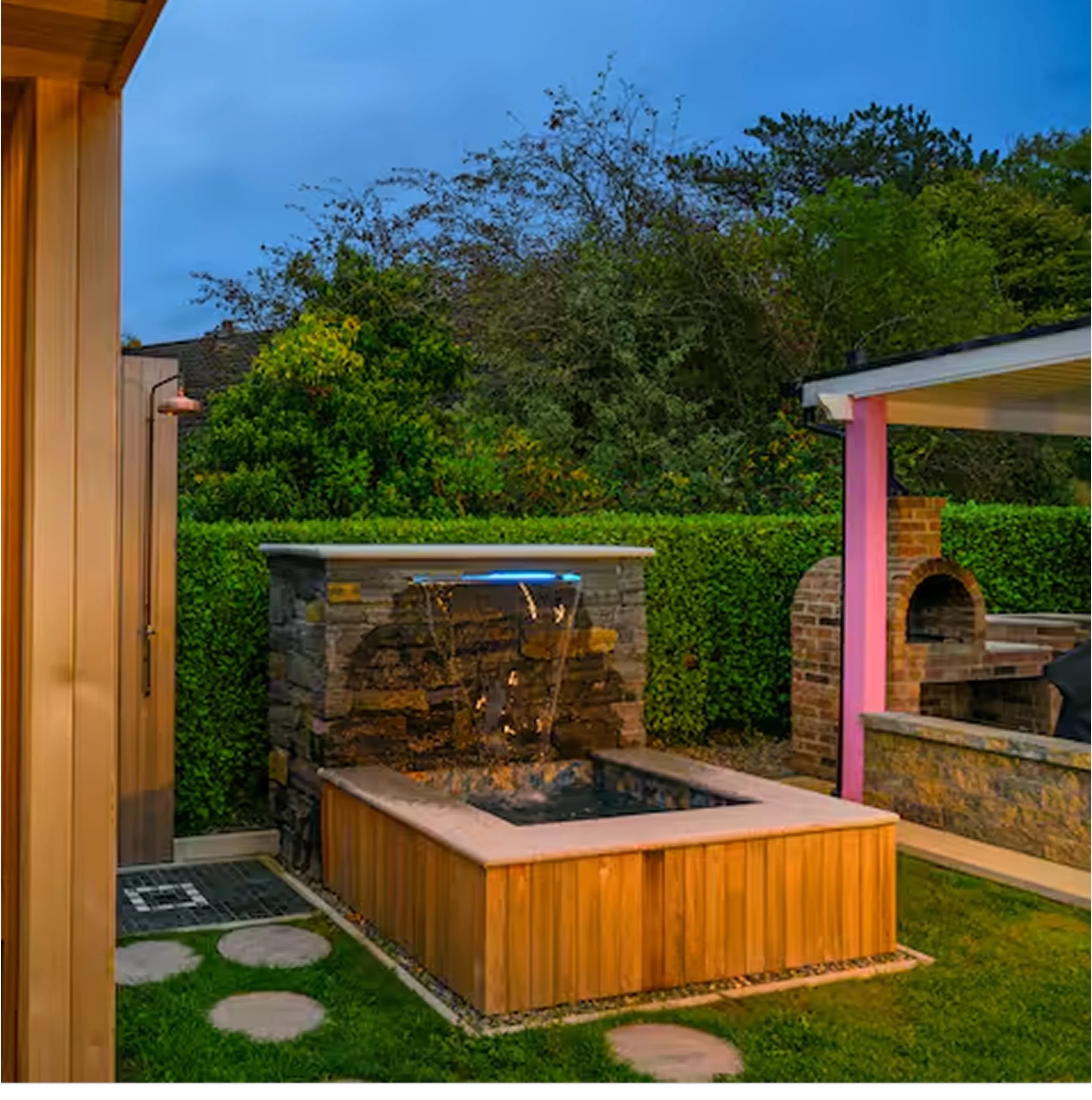 An image focusing on the plunge pool at Lily's Pink House, in the background, you can also see the Brick Pizza Oven