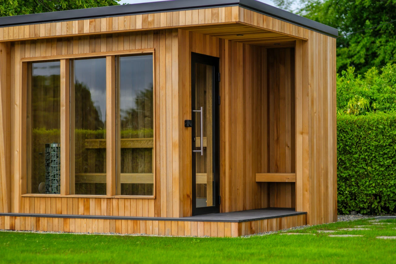 An image of the sauna at Lily's Pink House close up showing the detail on the wood construction, the bench inside, and the hot coals.