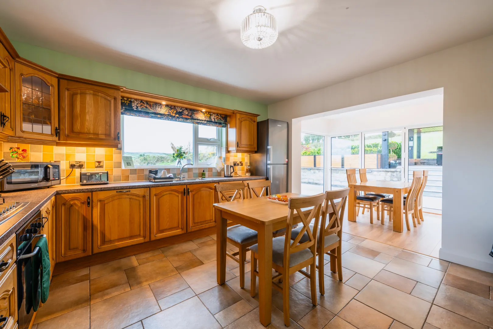 An image showcasing the Dining room and kitchen at Rosie's Cottage